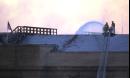 Firefighters continue to pour water on the roof of the Pentagon in Arlington, Va., Wednesday, Sept. 12, 2001, the day after a hijacked airliner flew into the structure. Fire and rescue officials say the fires following yesterday's attack are mostly contained. But they say they're having problems with fires under the roof.  (AP Photo/Steve Helber)